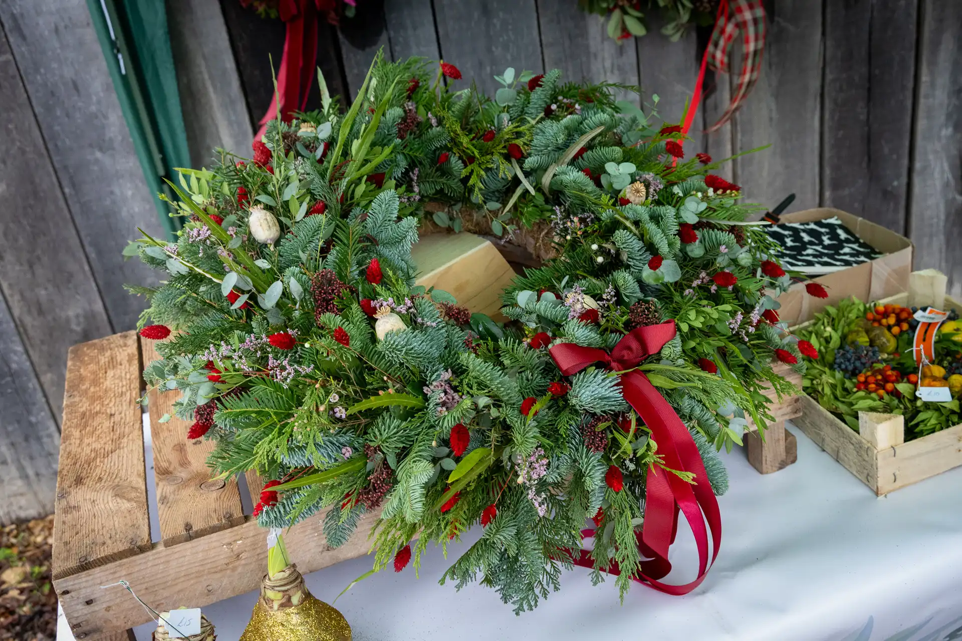 Christmas wreaths on the Sarah Freeman Floristry stall at the Ashdon Christmas Market at the Rose & Crown