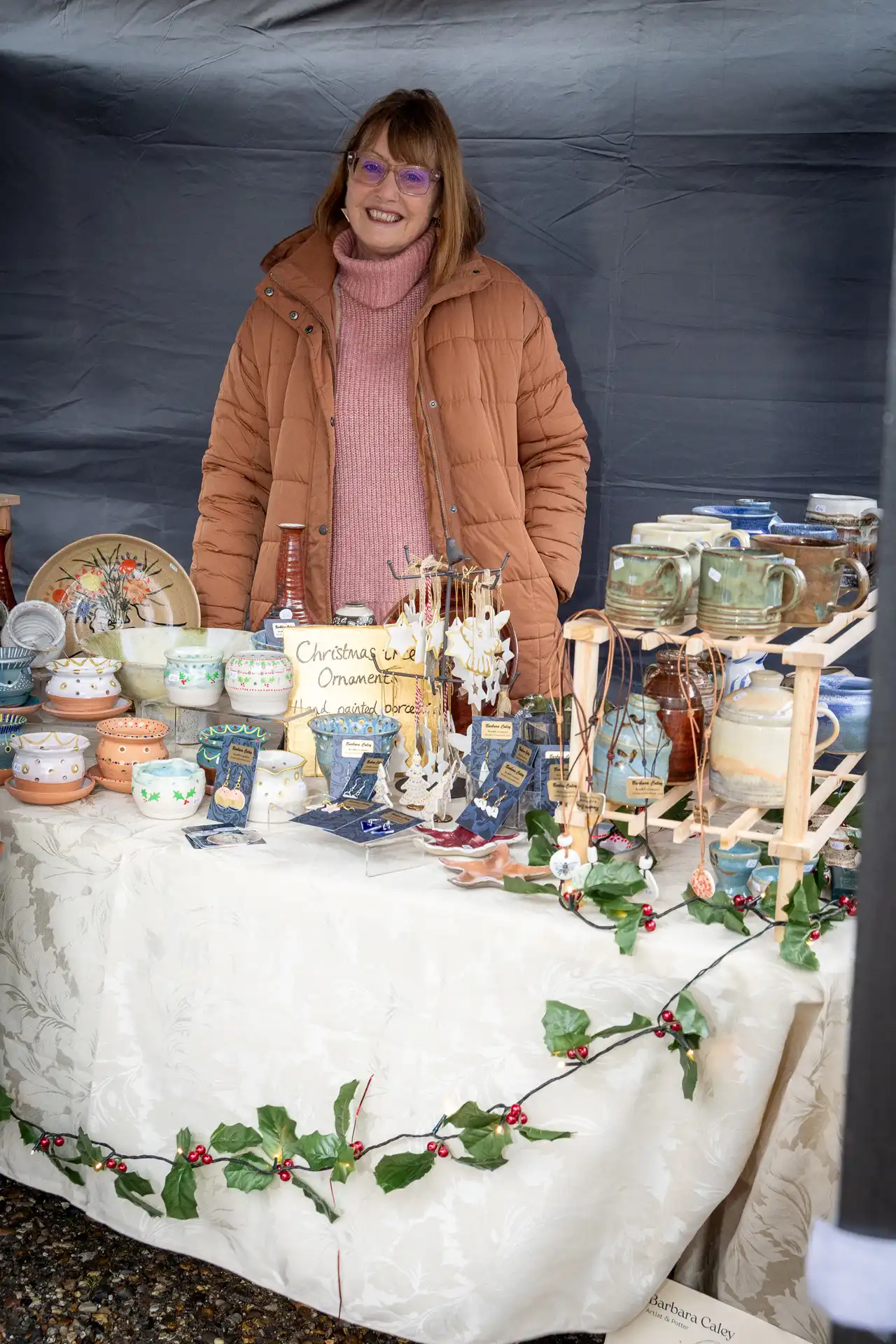 A stallholder with handmade pottery at the Ashdon Christmas Market at the Rose & Crown