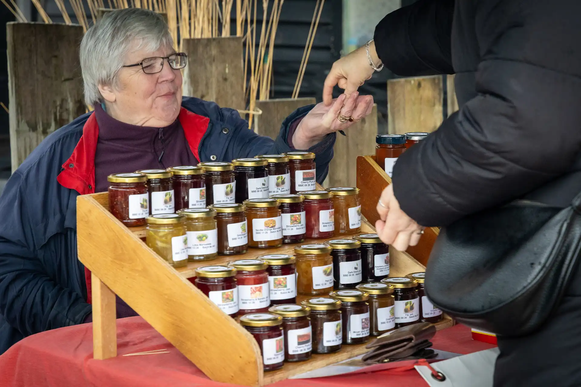 Jams and preserves for sale at the Jam Trolley stall at the Ashdon Christmas Market at the Rose & Crown