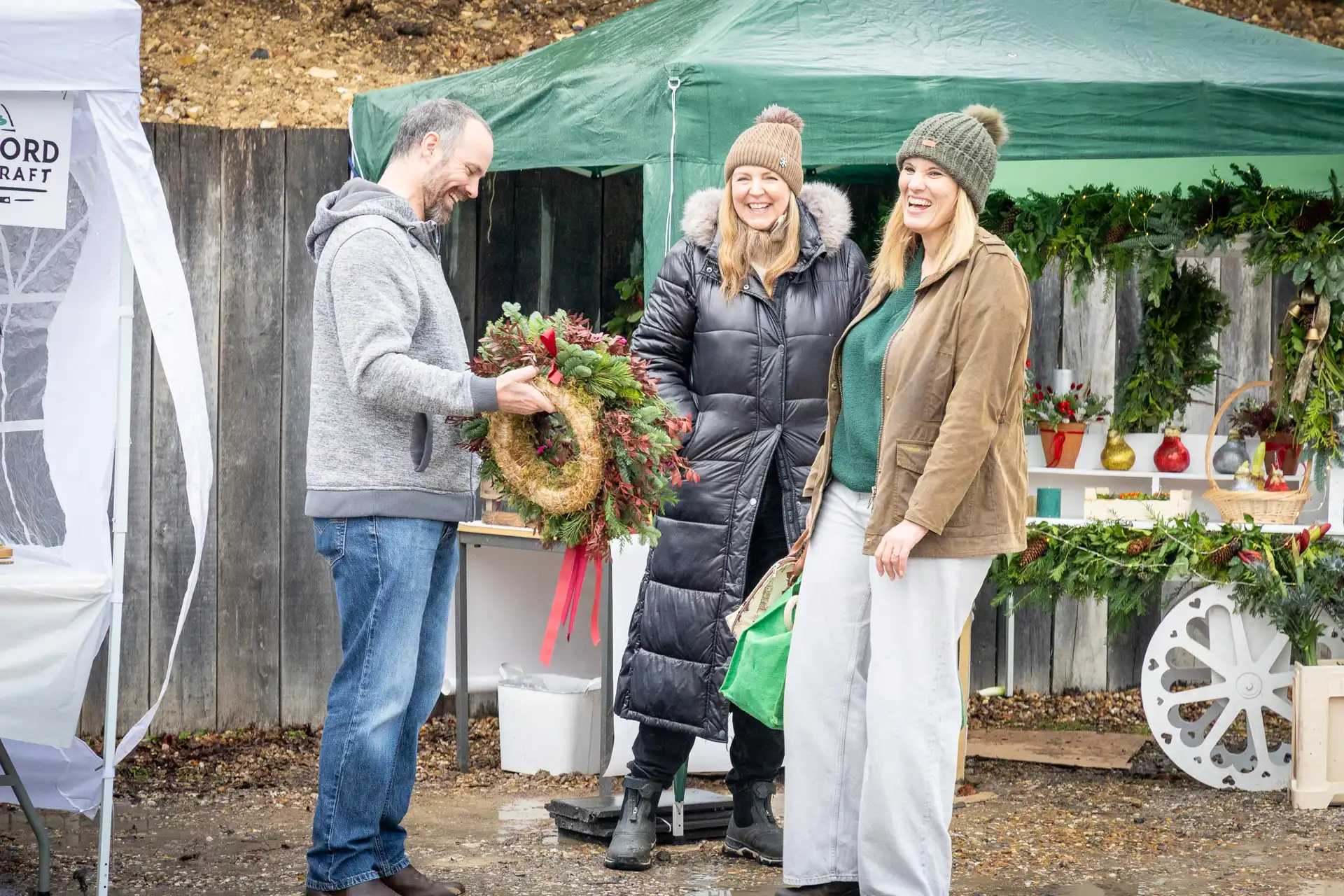 Choosing a wreath A shopper choosing a Christmas wreath at the florist’s stall at the Ashdon Christmas Market at the Rose & Crown